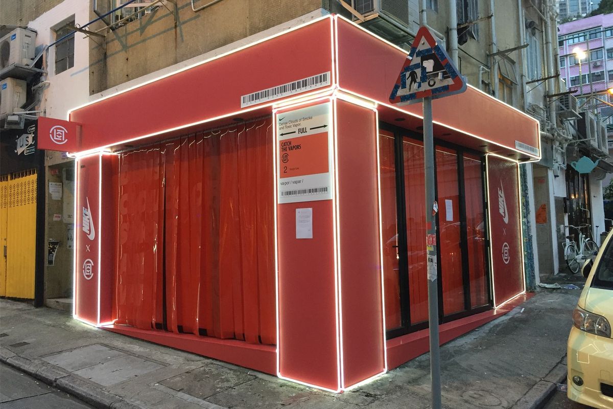 Red Nike x CLOT corner pop-up with LED edge lighting at dusk