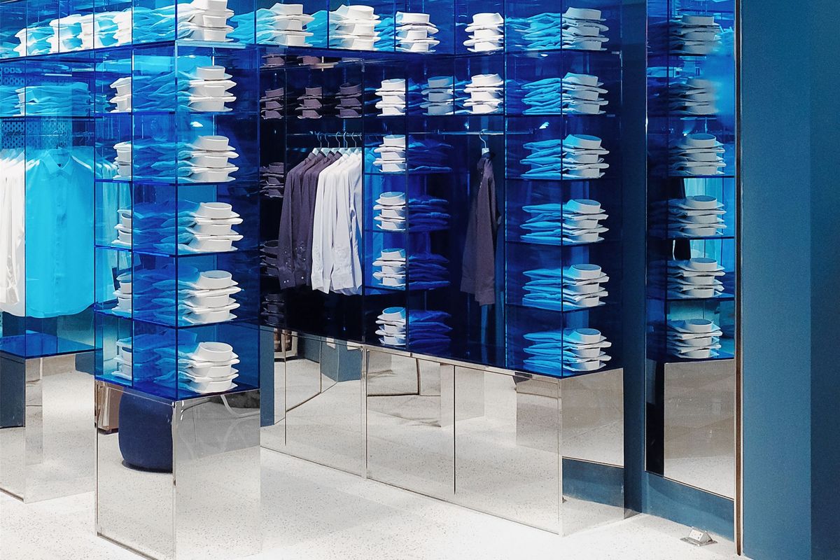 DETERMINANT store with blue acrylic cube shelving and mirrored plinths