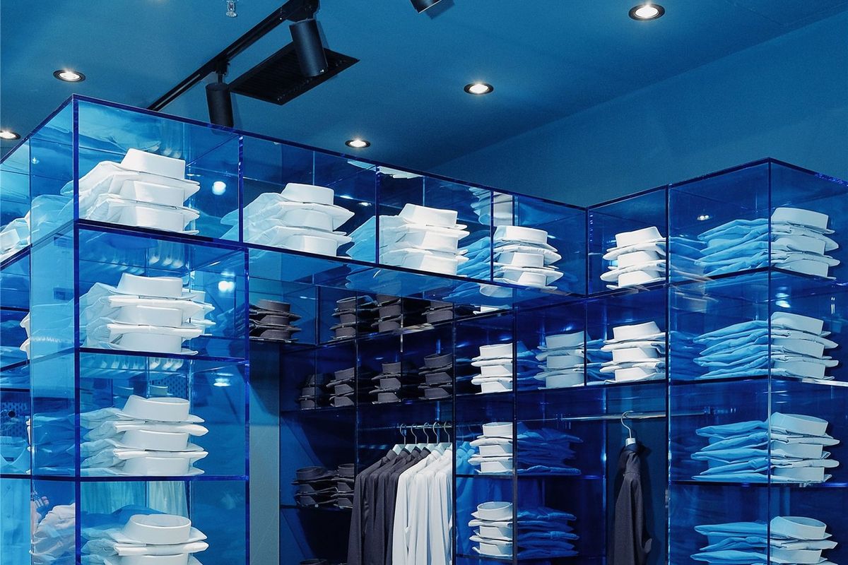Corner of the blue acrylic shelving system in a DETERMINANT store