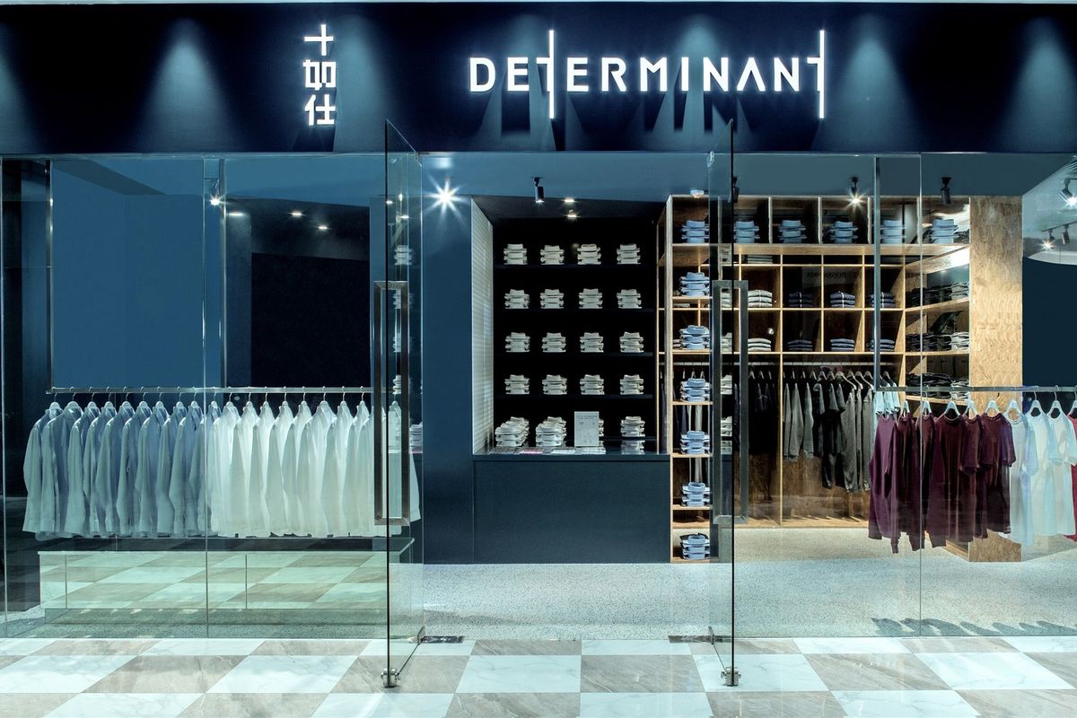 DETERMINANT storefront with navy fascia, glazing and timber shelving behind
