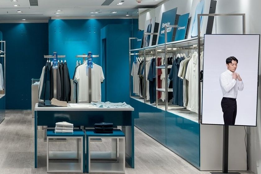 DETERMINANT store interior with teal walls and shirt displays