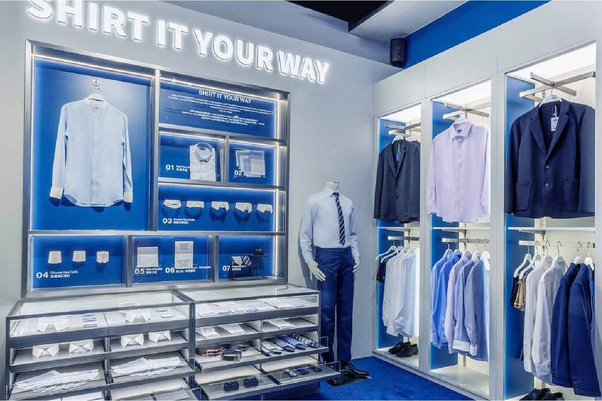 DETERMINANT store: backlit “Shirt it your way” fit wall with blue niches