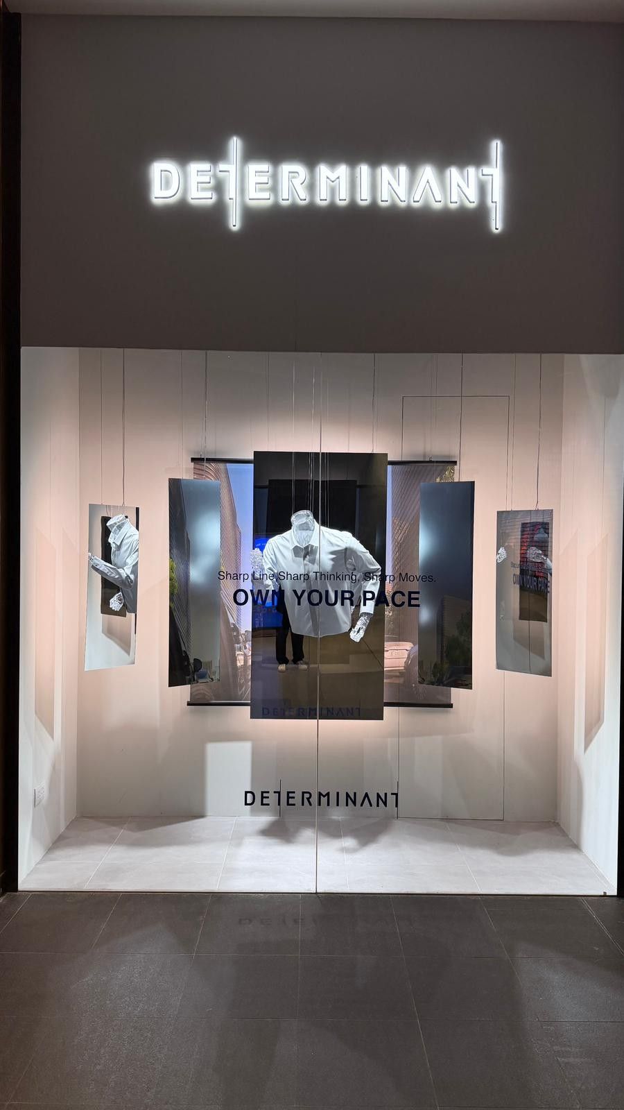 DETERMINANT window display seen from the mall, fascia logo above